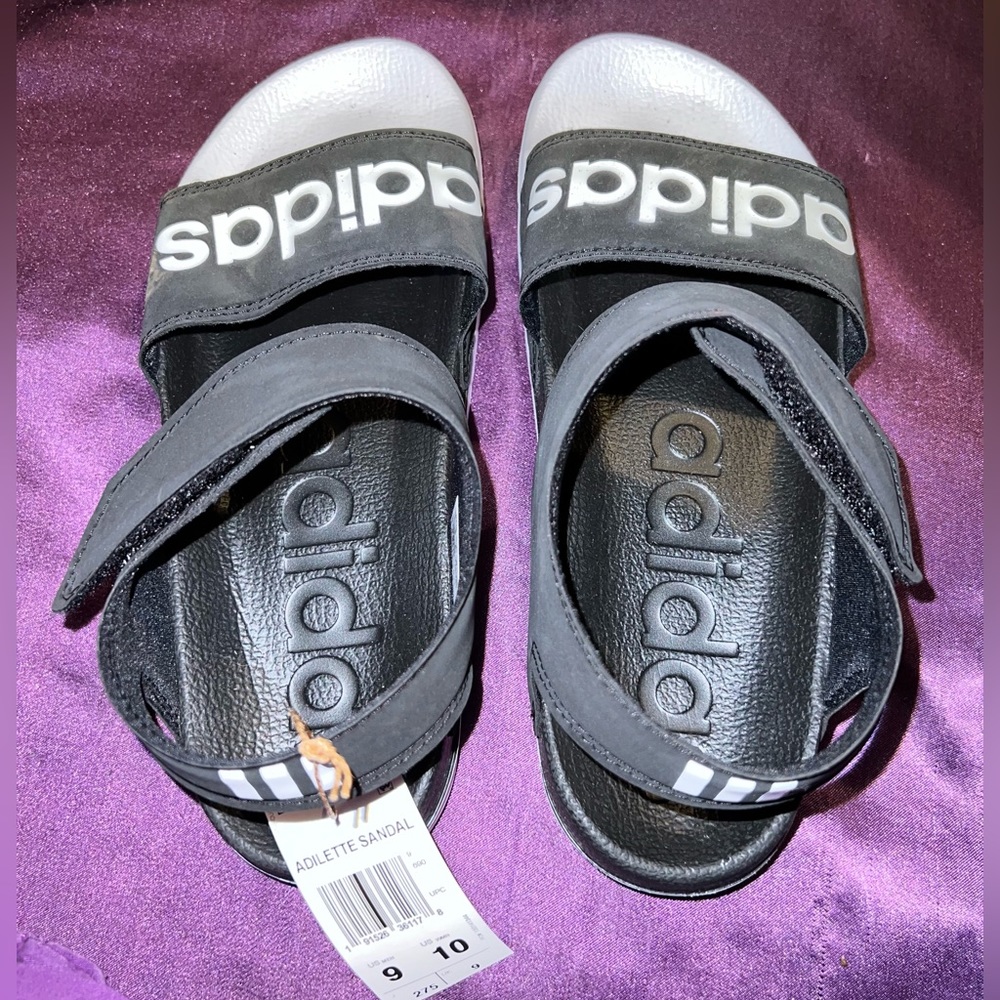 Black and white adidas slip ons
